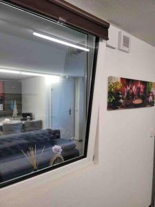 a window in a room with a bed in a room at Lakeview Basement Apartment near Interlaken in Niederried