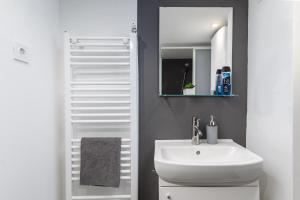 uma casa de banho com um lavatório e um espelho em Industrial Westend em Budapeste