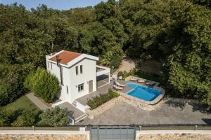 an aerial view of a house with a swimming pool at Villa Nature, Heated Pool in Kalyves
