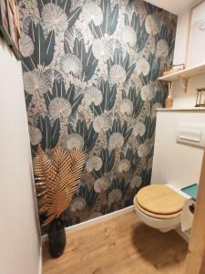 a bathroom with a black and white wallpaper with a toilet at Studio vieille ville tout équipé sans ascenseur in Menton