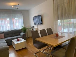 a living room with a table and a couch at Apartman MERI in Strmec Samoborski