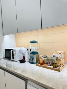 a kitchen counter with a coffee maker and a blender at Room in the Heart of Historic Lisbon on Rua Augusta in Lisbon
