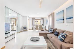 a living room with a couch and a tv at Garden Hill Relax & Old Town by OCvillas in Albufeira