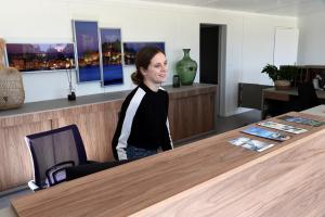 a woman sitting at a table in an office at Camping Bella Vista in Calvi +99 photos