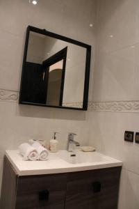 a bathroom with a sink and a mirror at Sublime studio - Gauthier in Casablanca