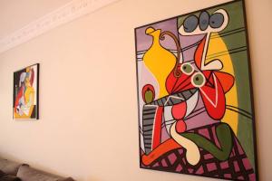 a painting hanging on a wall in a living room at Sublime studio - Gauthier in Casablanca