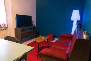 - un salon avec un canapé et une télévision dans l'établissement Alle porte del Montefeltro - Maison Torriana, à Torriana