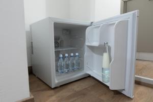 an open refrigerator with bottles of water in it at Incantevole Loft - Centro Storico- Wi-Fi- Ad un passo da tutto in Terracina