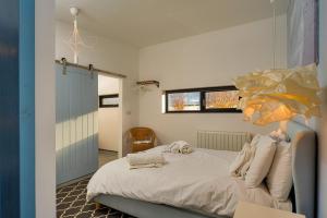 a bedroom with a bed with towels on it at Finest Retreats - Sea Barn in Stalham