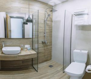 a bathroom with a shower and a toilet and a sink at Hotel Sky Station in Tbilisi City