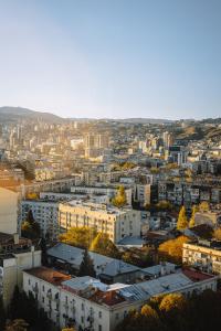 an aerial view of a city with buildings at Hotel Sky Station in Tbilisi City