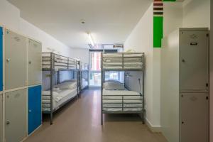 a room with three bunk beds and a hallway at Ganbara Hostel - Self Check In in Bilbao