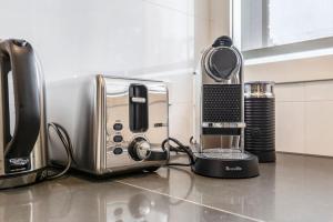 a kitchen counter with a toaster and a coffee maker at 'Caulfield Charm' Chic Inner-City Refuge in Melbourne