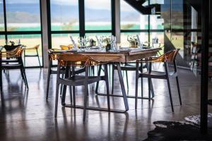 a wooden table with chairs and glasses on it at Cellar1947 in Robertson