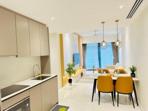 a kitchen and living room with a table and chairs at Eaton Service Apartment at KLCC in Kuala Lumpur