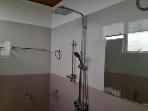 a bathroom with a shower and a mirror at Creek View Inn in Nuwara Eliya