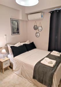 a bedroom with a large white bed and a window at LD Studio Larissa in Larisa