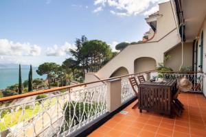 a balcony with a table and a view of the ocean at MINERVA HOUSE in Rapallo