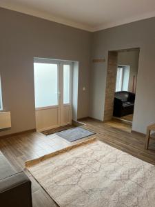 an empty living room with a door and a rug at Benny & Bella Guest House in Oradea
