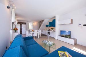 een woonkamer met een blauwe bank en een tafel bij BELLAGIO BALCONE in Bellagio