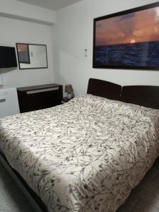 una camera da letto con un letto con un grande schermo a parete di Casa Vacanza Mediterraneokr - AAUT a Crotone