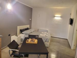a small room with a bed and a table in it at B&B SOFIA in Santo Stefano Ticino