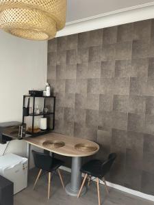 a dining room with a table and two chairs at Chez Auguy et Deborah in Antwerp