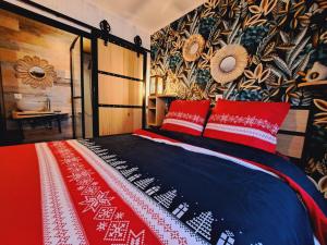 a bedroom with a bed with red pillows at Gîte Chez Simone in Houffalize