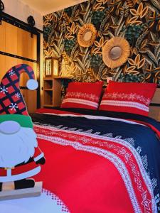 a bedroom with a bed with red pillows and a red blanket at Gîte Chez Simone in Houffalize