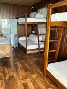 a room with three bunk beds in a house at Hideout Backpackers Hostel in Darjeeling