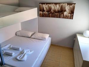a small room with a bed with towels on it at Apartment Damir - Novalja in Novalja