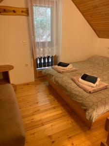 two twin beds in a room with a window at Apartments Nune 2 in Zreče