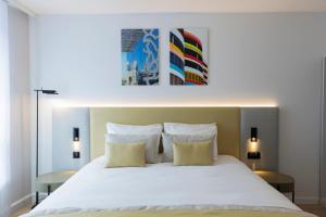 a bedroom with a large white bed with two pillows at Crowne Plaza - Marseille Le Dôme in Marseille