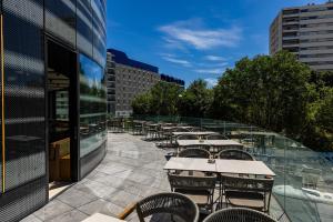 a row of tables and chairs on a patio at Crowne Plaza - Marseille Le Dôme in Marseille