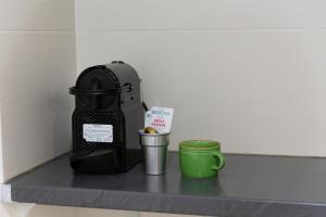 a coffee maker and a cup on a counter at Magnifique studio 20 m2 - Paris - Disneyland in Noisy-le-Grand