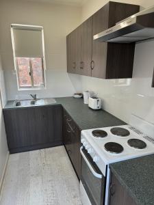 a kitchen with a stove and a sink at Away on Blende Studio Loft in Broken Hill