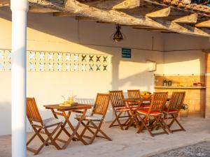a group of wooden tables and chairs in a room at Son Flor Agroturisme in Santa Margalida