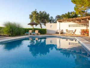 a swimming pool with blue water in a yard at Son Flor Agroturisme in Santa Margalida