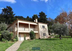 a large house in a field with trees in the background at MyStay - Casa do Carmo in Alvite