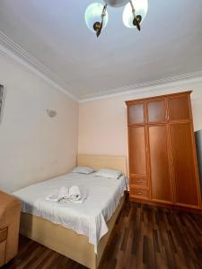 a bedroom with a bed and a wooden cabinet at Apartment on SARYAN street 2/12 in Yerevan