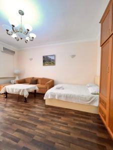 a bedroom with two beds and a couch at Apartment on SARYAN street 2/12 in Yerevan
