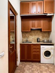 a kitchen with a sink and a washing machine at Apartment on SARYAN street 2/12 in Yerevan