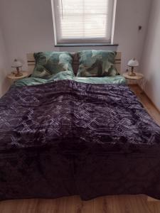 łóżko z czarną kołdrą w sypialni w obiekcie La Casa De Roland w Wieliczce