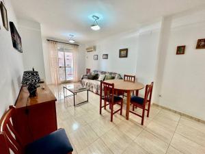 a living room with a table and a couch at Apartamento Costa Marina II REF. 020 in El Borseral