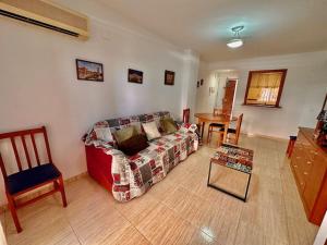 a living room with a couch and a table at Apartamento Costa Marina II REF. 020 in El Borseral