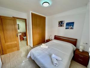 a bedroom with a bed with two towels on it at Apartamento Costa Marina II REF. 020 in El Borseral +7 photos