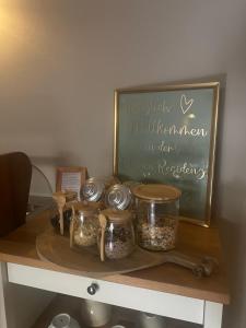 a table with jars and a chalkboard with a sign at Kleine Residenz am Schloss in Hochheim am Main