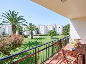 a balcony with a table and chairs and palm trees at 0326 Apartment in Calella de Palafrugell in Calella de Palafrugell