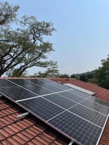 a group of solar panels on top of a roof at Plum Cottage in Nelspruit