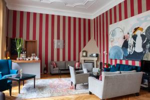 a living room with red and white striped walls at Small Luxury Hotel Altstadt Vienna in Vienna